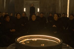 Sister Valya (Jessica Barden) sitting among other Bene Gesserit sisters in a still from Dune Prophecy