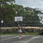 Lily Bowman has fun playing tennis with a friend.