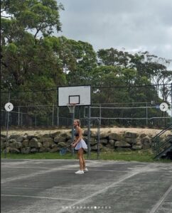 Lily Bowman has fun playing tennis with a friend.