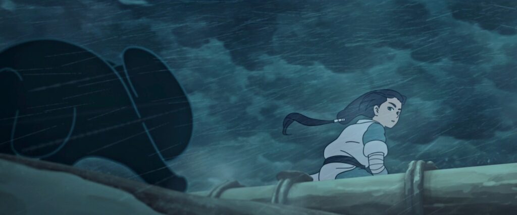 A man in Chinese robes with long, blue hair pulled back in a ponytail sits on a raft in a driving thunderstorm and looks back over his shoulder in surprise at a hunched, hissing little black cat in the animated movie The Legend of Hei