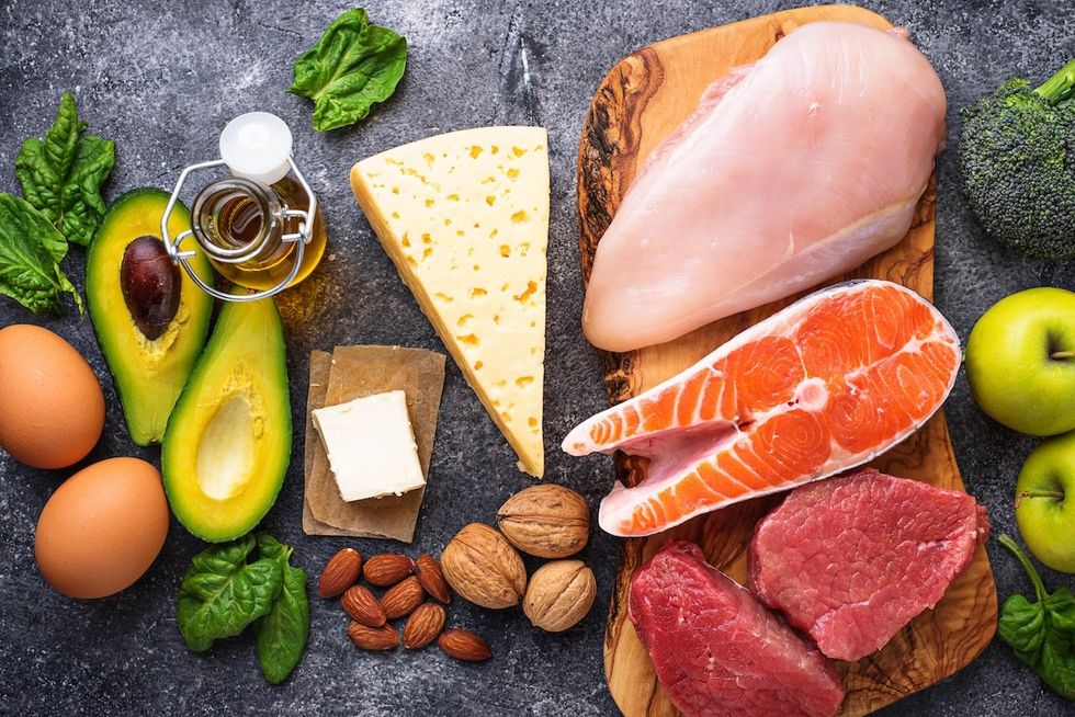 assortment of low-carb foods on a slate background