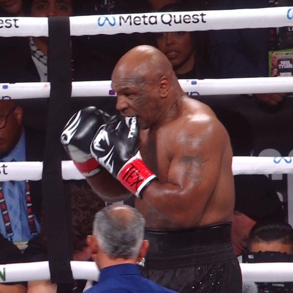 Mike Tyson bites his glove against Jake Paul