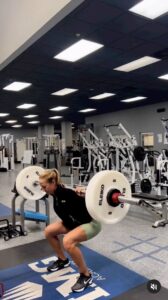 Nelly Korda does squats with weights and a barbell.