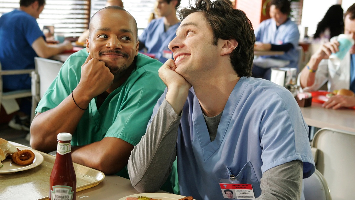 Donald Faison and Zach Braff make eyes at each other in Scrubs.