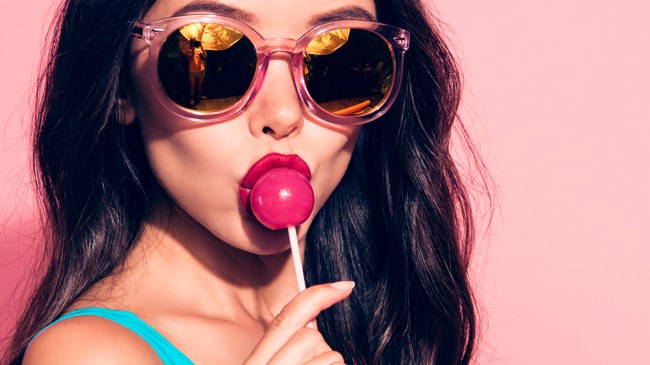 girl in sunglasses kissing lollipop