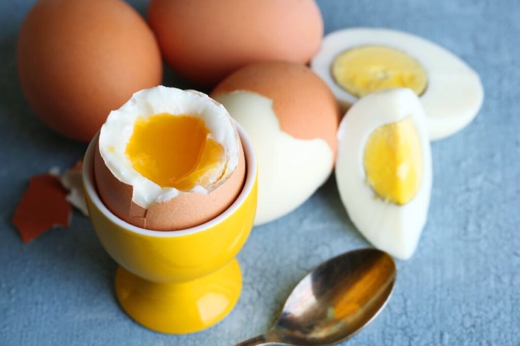 boiled eggs on table, eggs next to spoon