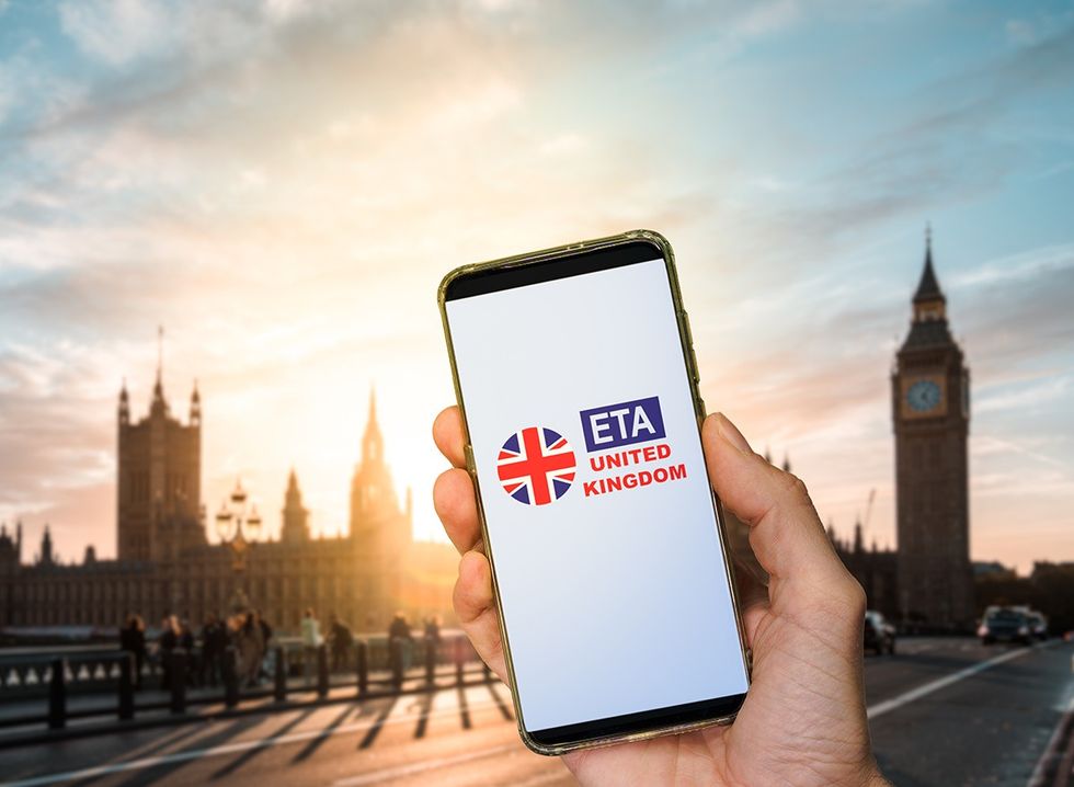 A mobile phone with ETA screen held in front of a London background