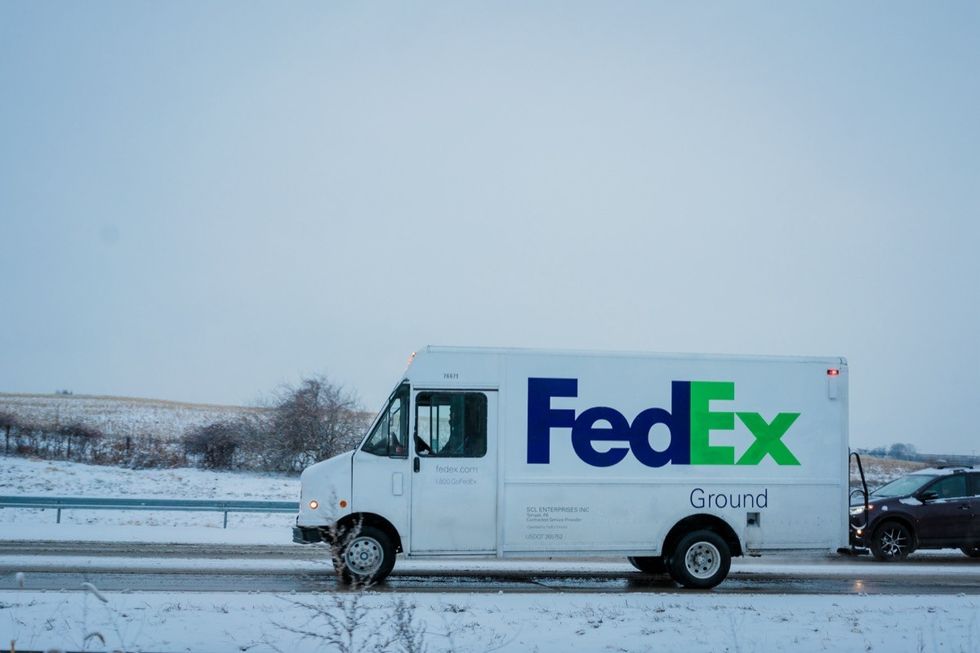 fedex ground truck driving in the snow