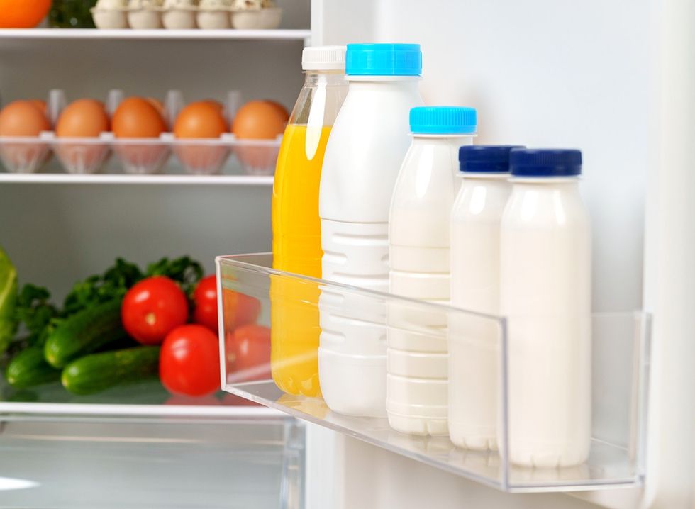 Milk bottles in the door of a fridge