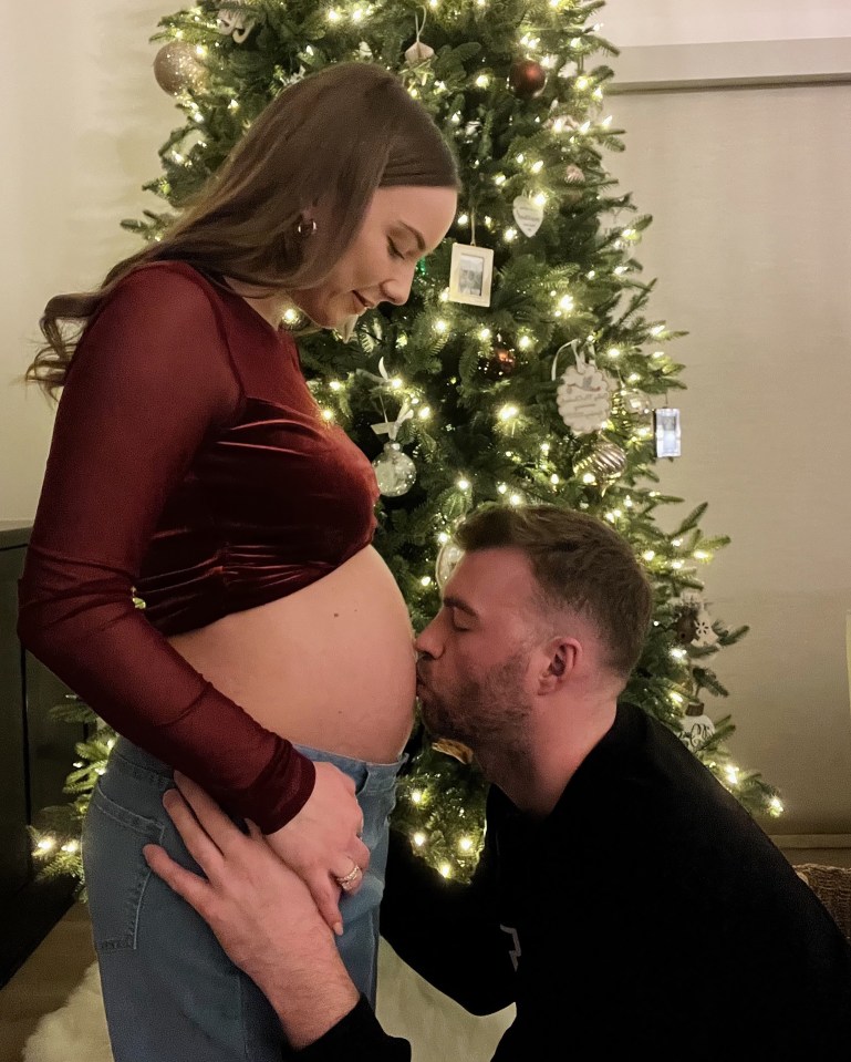 Husband Evan McClintock gave it a kiss in front of their Christmas tree