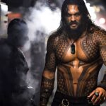 Shirtless Jason Momoa walking through steam on a submarine in Aquaman