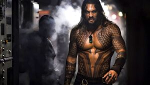 Shirtless Jason Momoa walking through steam on a submarine in Aquaman