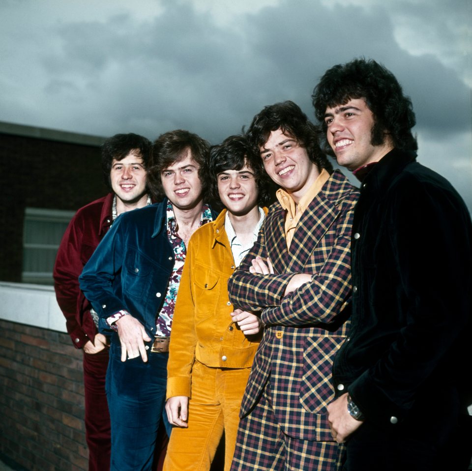 Wayne, seen second from the left, smiled alongside his brothers on a trip to London, England, in 1974