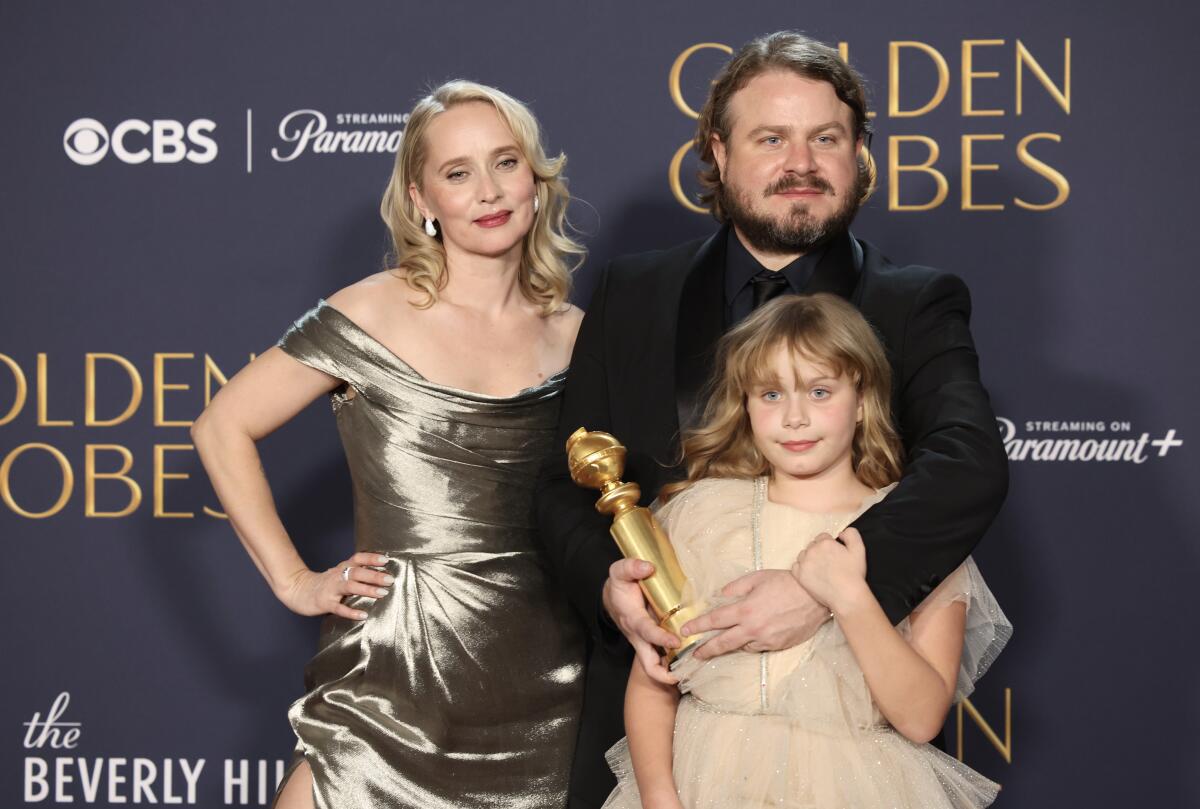 "The Brutalist" filmmakers Mona Fastvold, Brady Corbet and daughter Ada at the Golden Globe Awards.