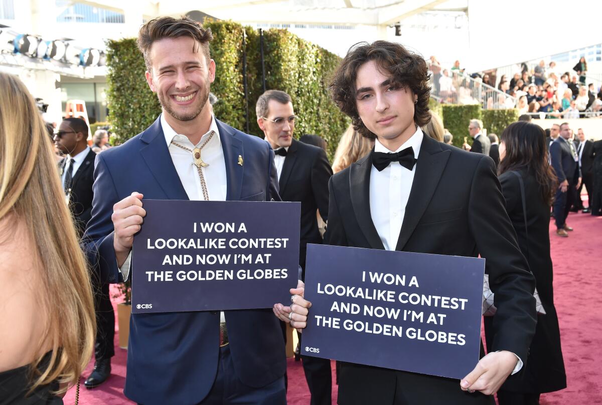 Lookalike contest winners Max Braunstein, left, and Miles Mitchell on the Golden Globes red carpet.