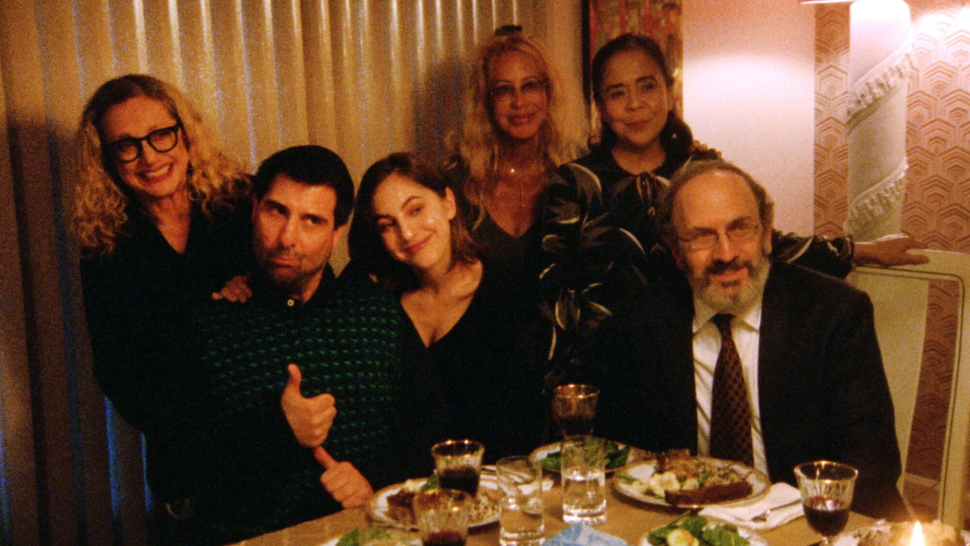 A group gathers around the dinner table in "Between the Temples."