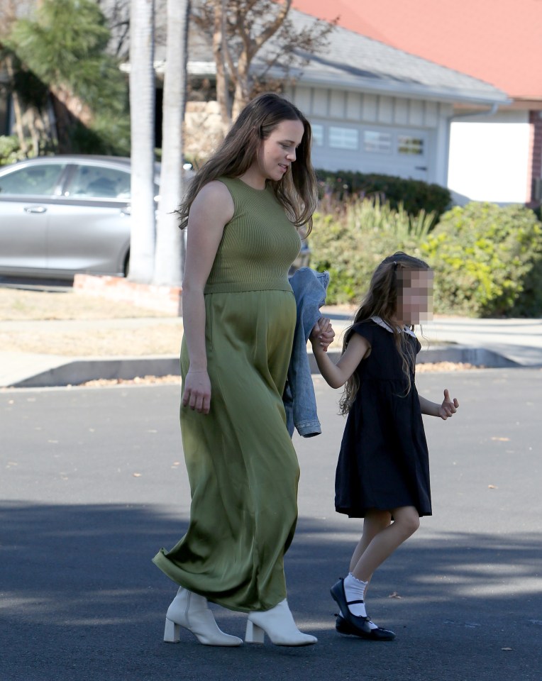 Doting mom Jinger held her daughter Felicity's hand as they left church