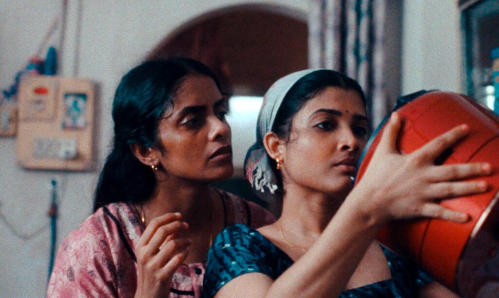 Two women look at a rice cooker in "All We Imagine as Light."