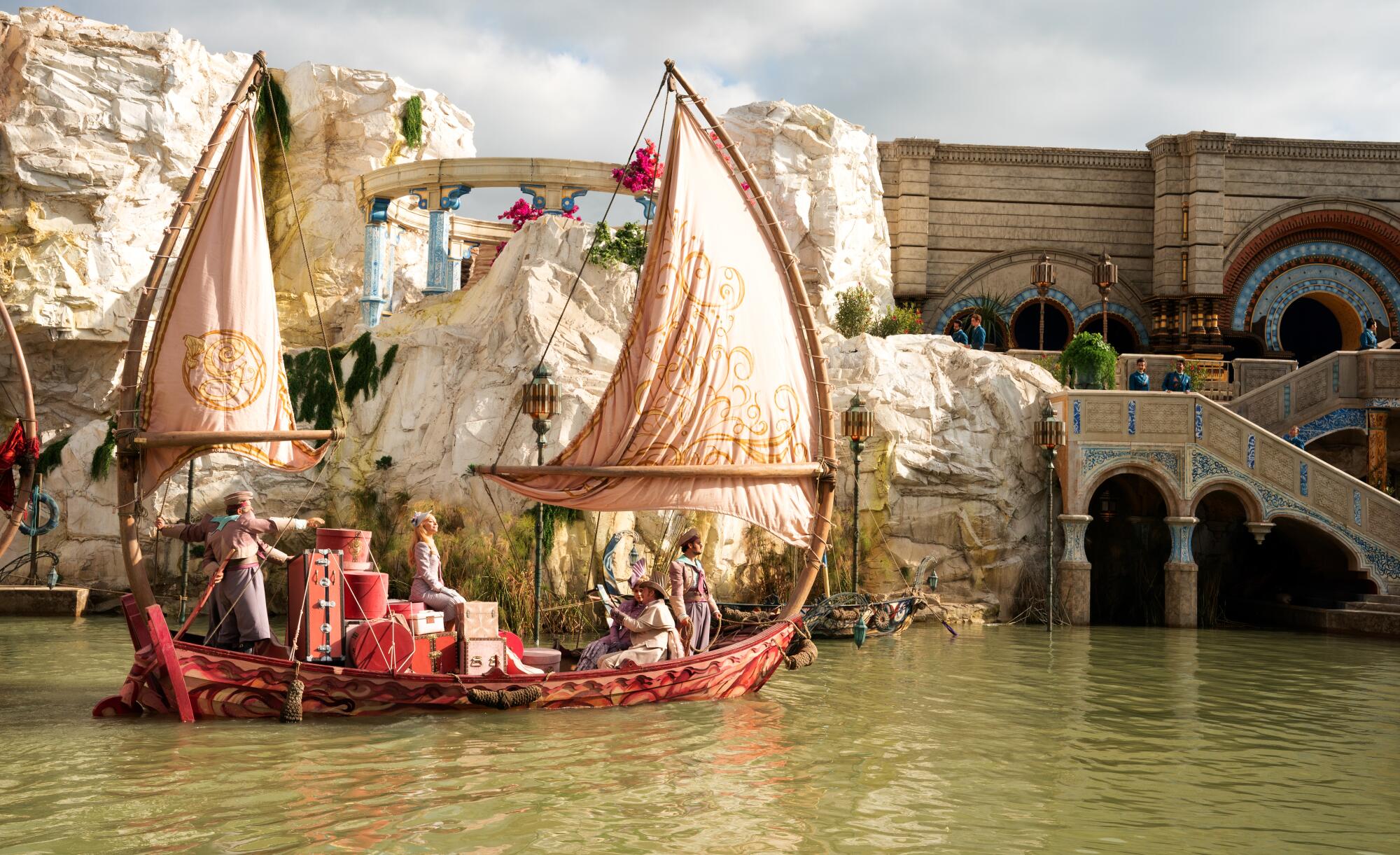 A fanciful sailboat carries a student and much luggage through the water. 