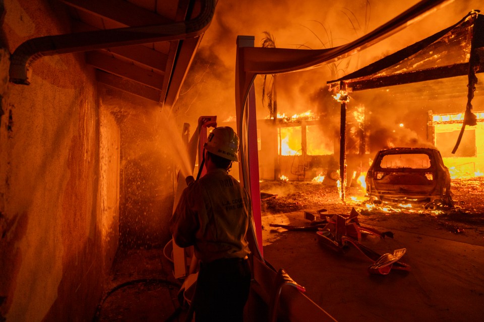 A firefighter battles the Eaton Fire on January 8 in Altadena, California