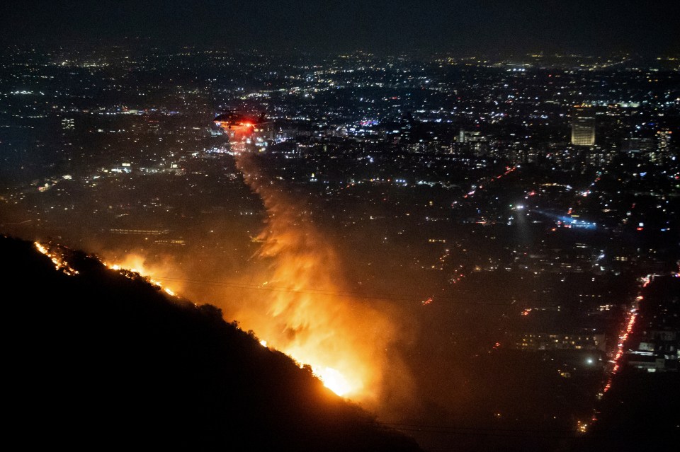 Water is dropped by helicopter on the burning Sunset Fire in the Hollywood Hills