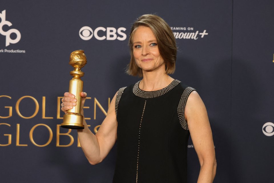 Jodie Foster holding a Golden Globe award.