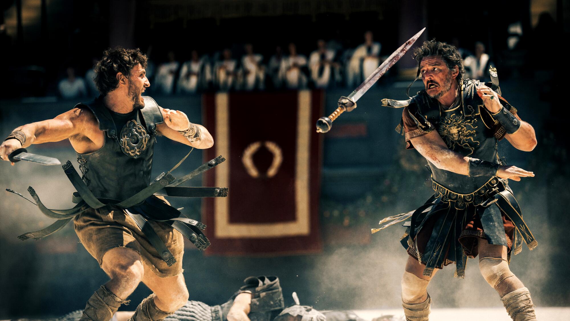 Two men in gladiator clothes battle with swords in "Gladiator II."