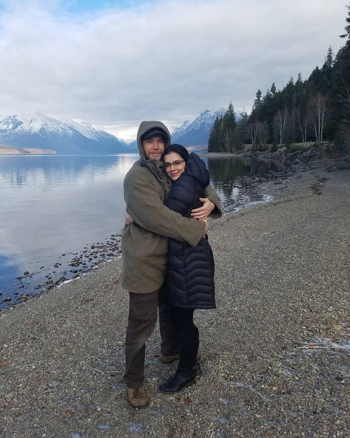 Adrienne Curry and Matthew Rhode hugging by a lake.