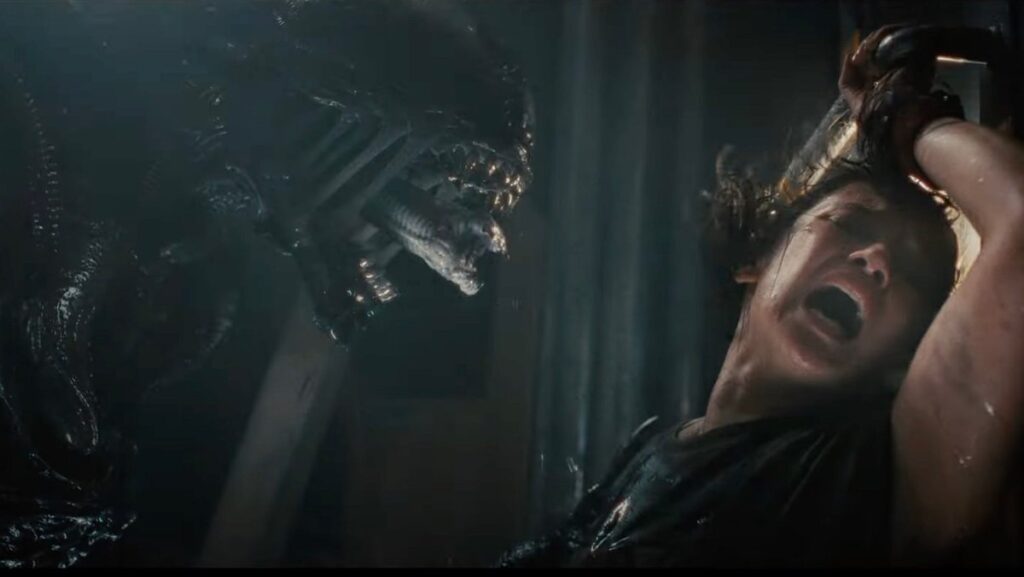 A xenomorph roars at Cailee Spaeny in Alien: Romulus.