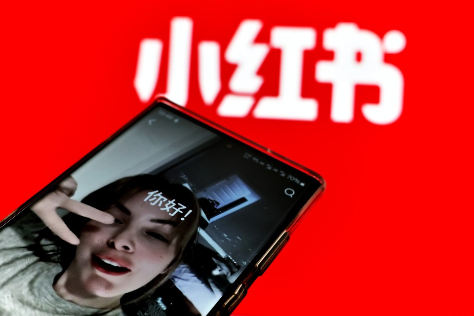 Photo illustration of a phone screen showing a woman making a video on the Xiaohongshu app.