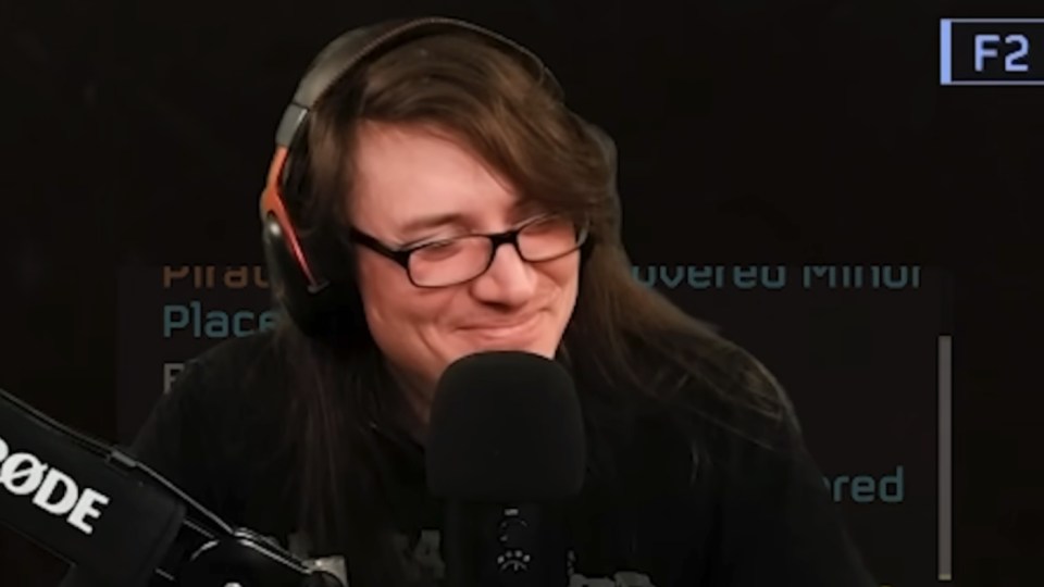 Streamer smiling into a microphone.