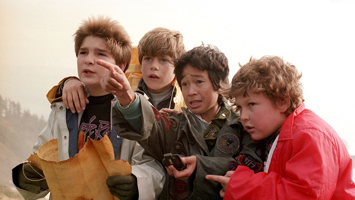 The Goonies hold their treasure map.