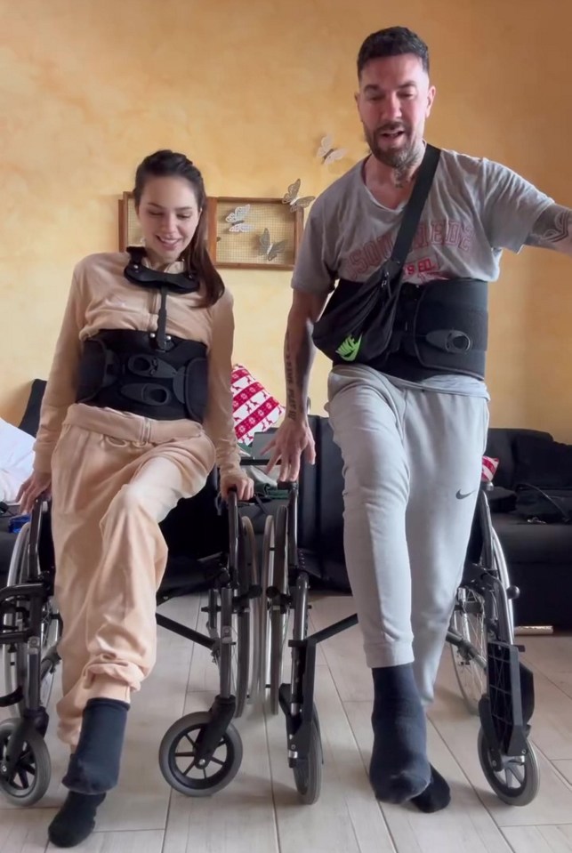 Couple in wheelchairs practicing walking during physiotherapy.