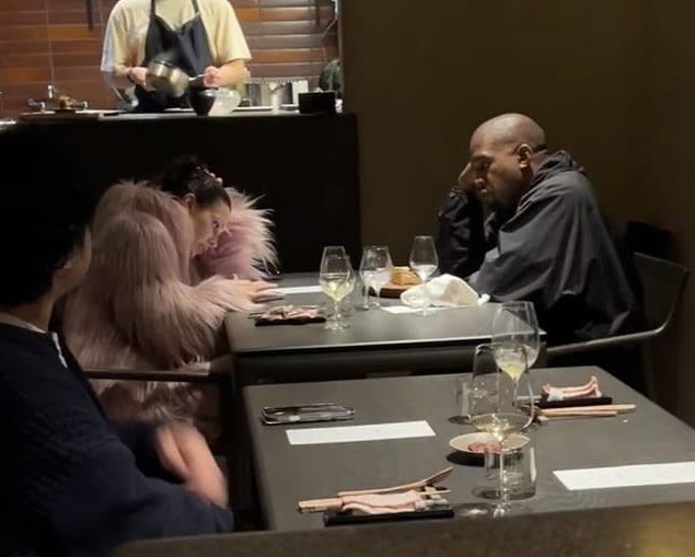 Kanye West and Bianca Censori at dinner.