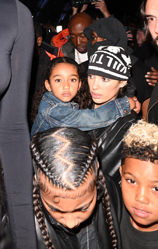 Bianca Censori with Kim Kardashian's children at Kanye West's concert.