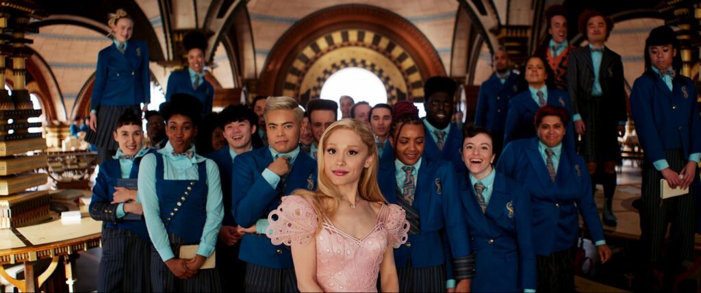 Ariana Granda as Glinda stands at the head of a group of classmates in "Wicked."