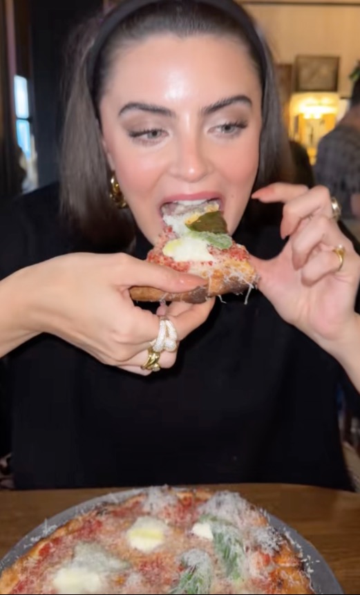 Woman eating pizza.