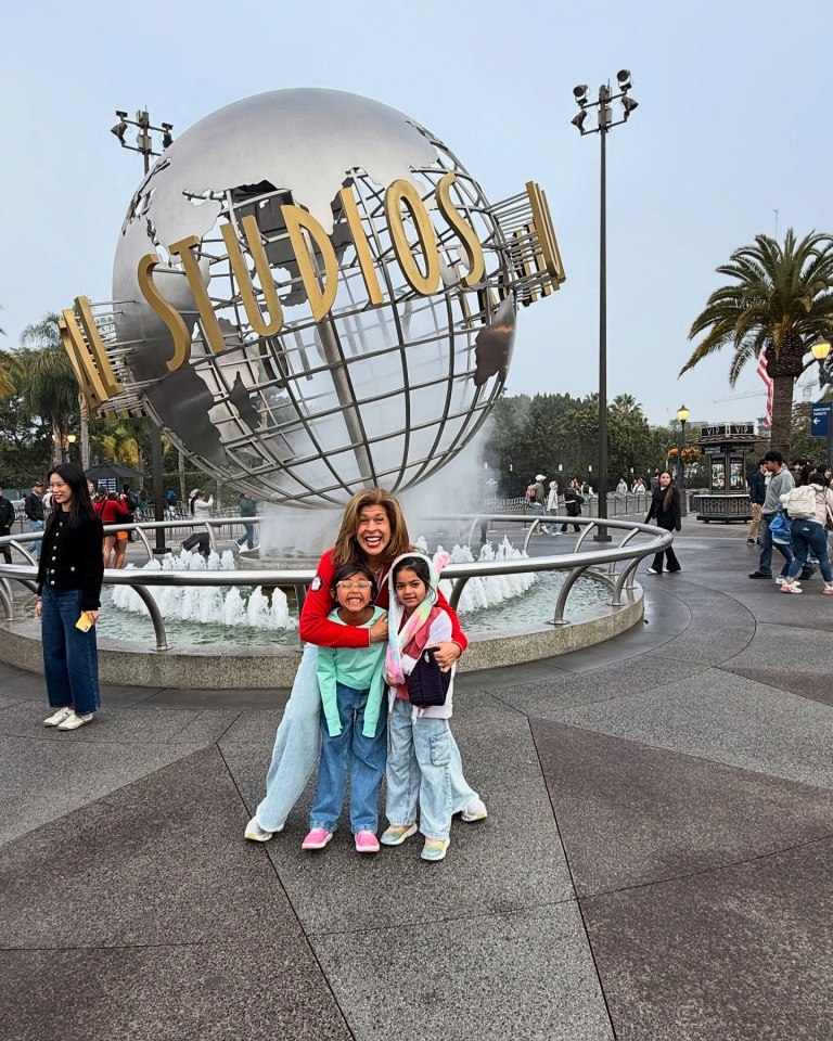 Hoda Kotb with her two daughters in front of the Universal Studios globe.