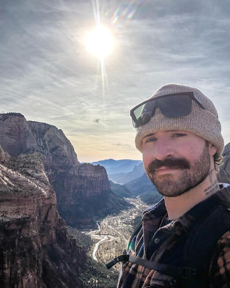 Portrait of Chris O’Donnell, a fitness influencer, overlooking a valley.