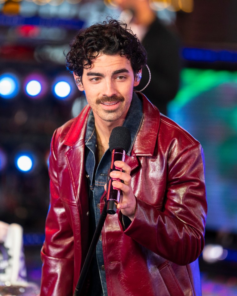 Joe Jonas of the Jonas Brothers performing on stage.