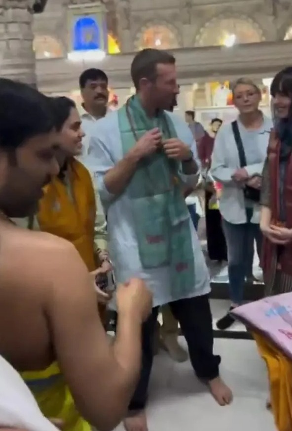 Chris Martin and Dakota Johnson at a temple.