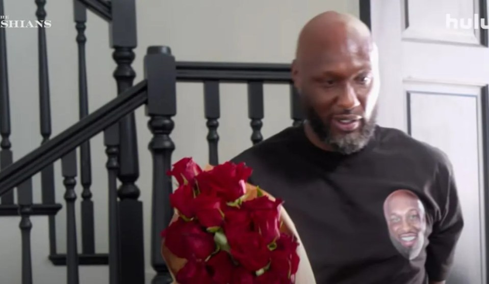 Lamar Odom holding red roses in a scene from The Kardashians.