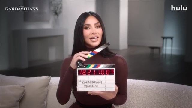 Kim Kardashian holding a clapperboard for The Kardashians season 6.