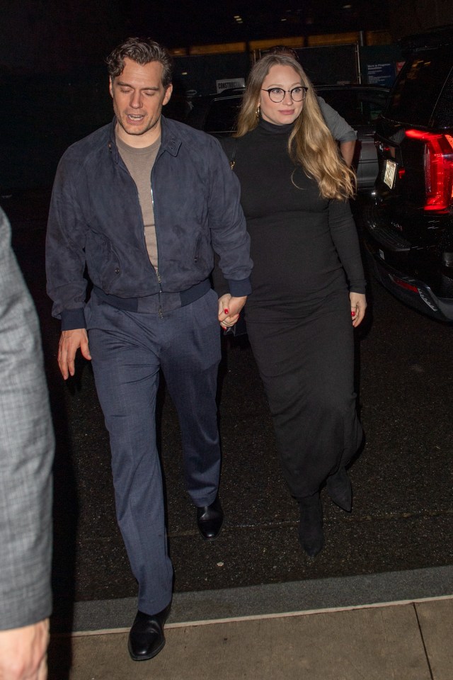 Henry Cavill and Natalie Viscuso holding hands.