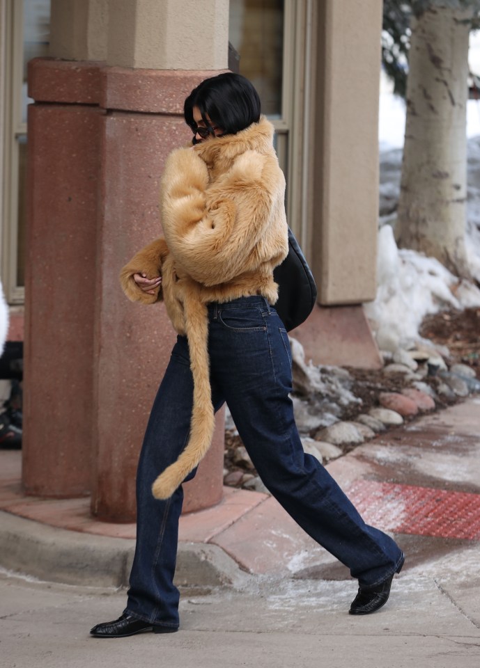 Kylie Jenner wearing a tan fur coat and jeans.