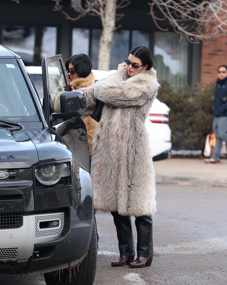 Kylie and Kendall Jenner arriving at a restaurant in Aspen, wearing fur coats.