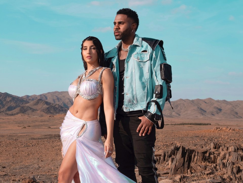 Jason Derulo and Nora Fatehi in a desert landscape.