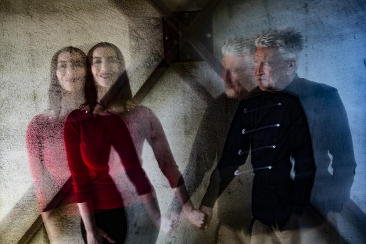 David Lynch and Chrystabell hold hands in a double-exposure photo.