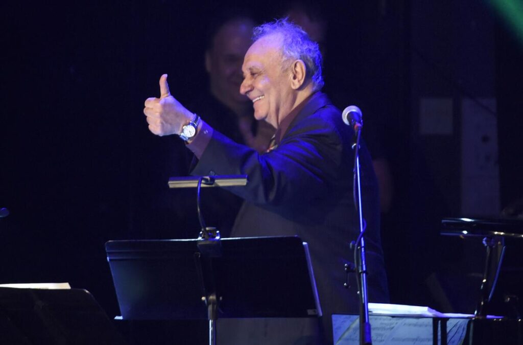 Angelo Badalamenti gives a thumbs-up  onstage.