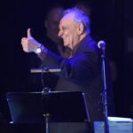 Angelo Badalamenti gives a thumbs-up  onstage.